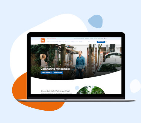 cambio-Website auf einem Laptop mit blauen und orangen Grafiken im Hintergrund